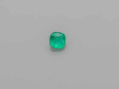 an emerald stone on a white surface
