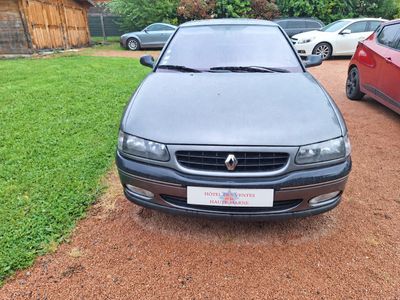 a picture of a car parked on the side of a dirt road