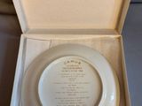 a white plate in a box with a poem on it