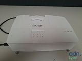 a white projector sitting on top of a white table