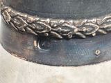 a close up of a metal object with a chain around it