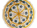 a yellow and blue plate with blue flowers on it