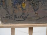 a painting on a wooden easel with a painting of a bird on it