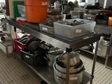 many pots and pans on a metal shelf in the kitchen