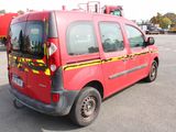 a red van that is parked in a parking lot