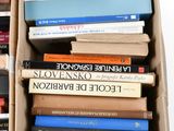 boxes of books are stacked on top of each other on a white surface