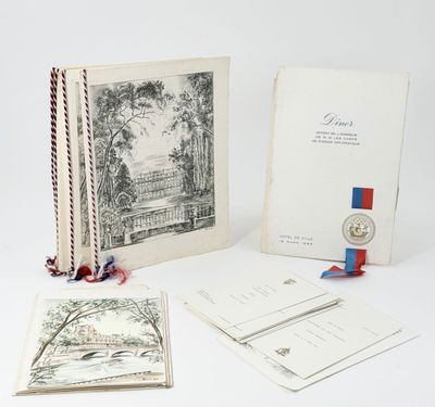 an open book with a medal and a bookmark sitting on top of it