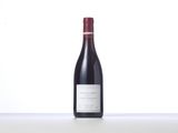 a bottle of red wine sitting on top of a table