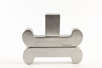 a metal object that is sitting on top of a white surface