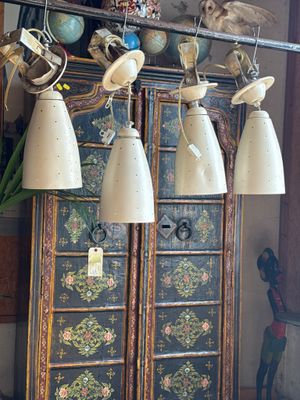 many lamps hanging from the ceiling in this room