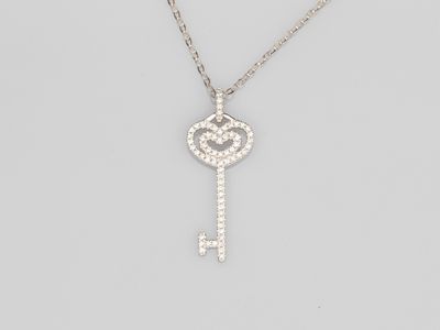 a diamond key pendant on a chain