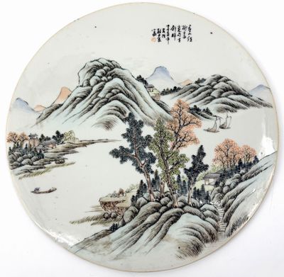 an image of a plate with a painting of mountains and trees