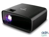 an image of a black projector with a purple light on it