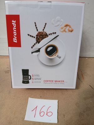 une boîte contenant une cafetière et un mot, posée par terre