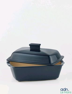 a black casserole dish with a lid on a white background
