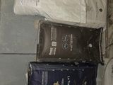 three bags of toilet paper sitting on the floor