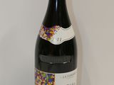 a bottle of wine with sprinkles on it
