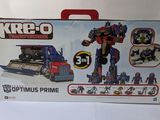 toys are in a box on a white surface with a red handle