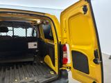 a yellow van with its door open in a garage