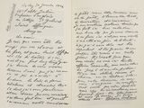 an open book with a handwritten letter on it sitting on top of a table