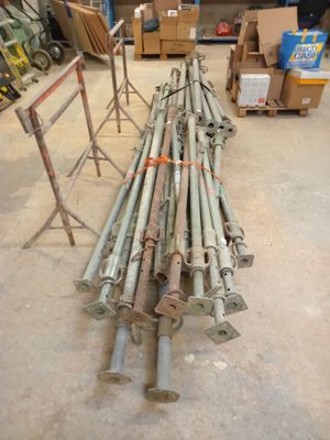 a pile of metal pipes and poles in a warehouse