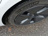 a close up of a tire on a white car