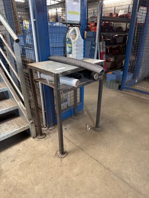 a table that is sitting in front of a set of stairs