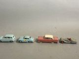 several toy cars are lined up in a row on a gray surface