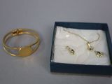 two rings and a necklace in a blue box