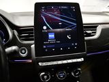 a car dashboard with a cell phone in the center of it