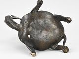 a bronze statue of a turtle on a white surface
