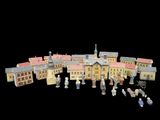 a group of toy figures that are standing in front of a building