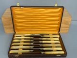 a case that has a set of eight knives in it