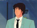 une photo d'un homme en costume-cravate debout devant une porte