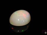 an image of a white oplite in the dark