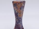 purple and brown vase on a white surface with a white background
