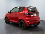 the rear end of a red car parked in a room