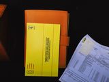 a yellow folder and some papers sitting on a table