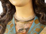 a statue of a woman holding a bottle of wine