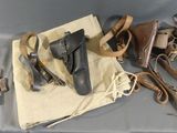 several pairs of leather shoes are laid out on a cloth bag