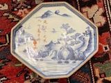 several plates are lined up on a rug on the floor