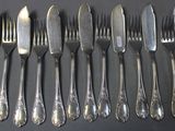 a lot of forks and spoons that are on the table