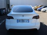 a white tesla model s parked in a parking lot