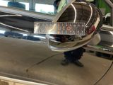 reflection of a man in a mirror on the side of a car