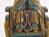 a statue of a woman sitting on a chair