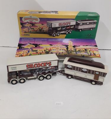 three toy trucks are sitting next to each other in front of a box