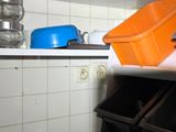 a stack of dishes on a shelf in a kitchen
