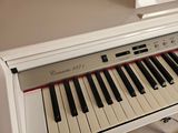 a white piano with black and red keys on it