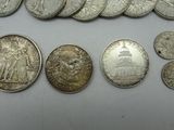 some silver coins are sitting on a table with a white background