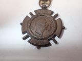 a small bronze medal with a picture of a man on it